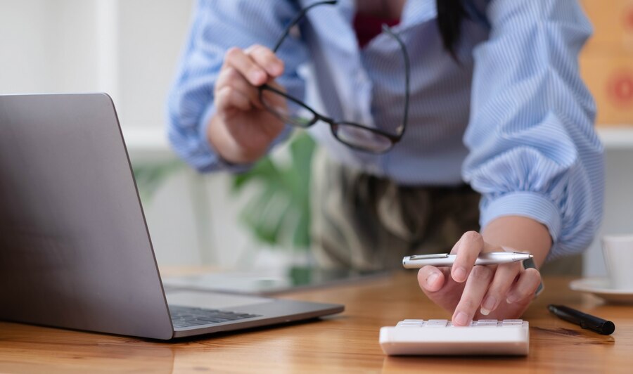 close-up-mulher-de-negocios-usando-calculadora-e-laptop-para-fazer-financas-matematicas-na-mesa-de-madeira-no-escritorio-e-negocios-trabalhando-fundo-imposto-contabilidade-estatisticas-e-conceito-de-pesquisa